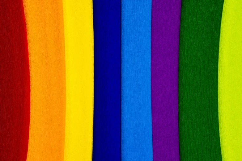 a close up of a rainbow colored wall, inspired by Morris Louis Bernstein, color field, bright uniform background, high quality fabrics textiles, lgbt flag, tonal colors outdoor
