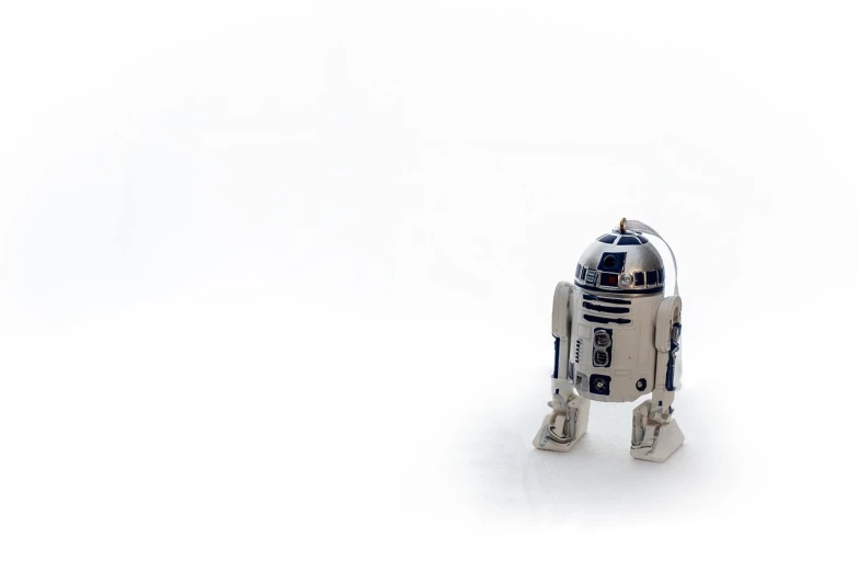 a close up of a toy robot on a white surface, minimalism, r2d2, wide shot photo, ebay photo, product introduction photo