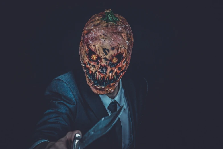 a man in a suit holding a knife, shutterstock, digital art, pumpkin head, clean brutal blooded face, taken with sony alpha 9, creepy sigma 75mm