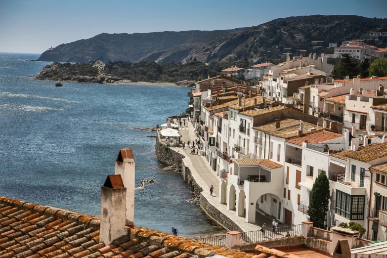 a number of buildings near a body of water, by Maurice Esteve, pexels contest winner, figuration libre, traditional corsican, tiled roofs, dezeen, ironman