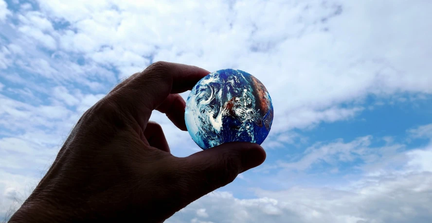 a person holding a glass globe in their hand, a picture, by Jan Rustem, blue marble, 8 k. filling of the view, viewed from below, blog-photo