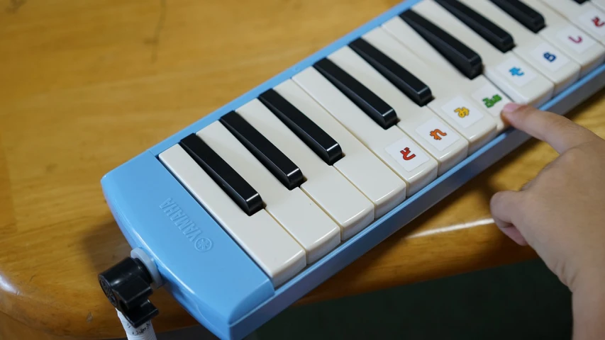 a close up of a child's hand on a keyboard, inspired by Bryan Organ, light blue, nintendocore, new musical instruments, けもの