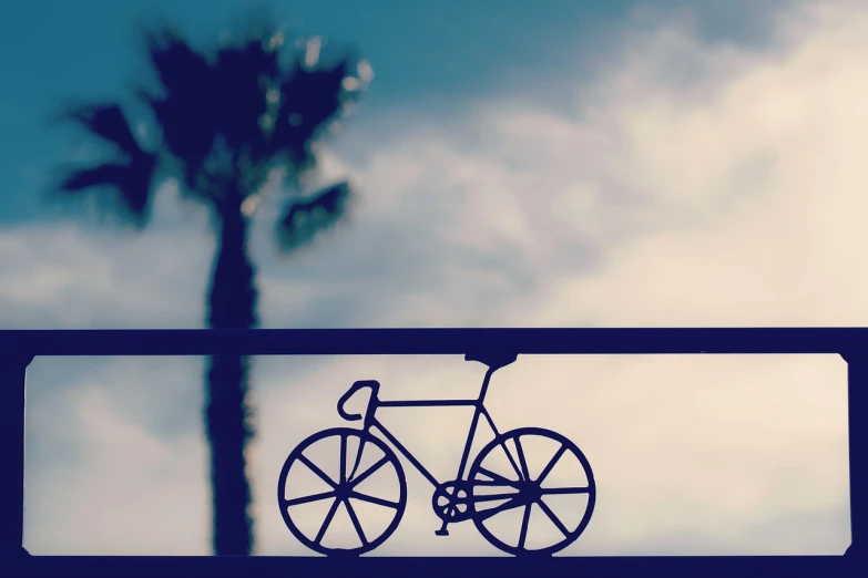 a bicycle sign with a palm tree in the background, a picture, postminimalism, railing, computer wallpaper, in profile, contraposto