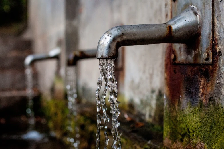 a close up of a faucet with water coming out of it, a photo, by Jakob Gauermann, renaissance, lined up horizontally, drainpipes, water torrent background, closeup photo