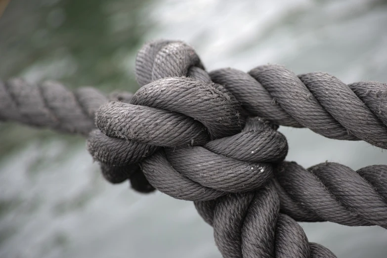 a close up of a knot on a rope, inspired by Sesshū Tōyō, pexels, wikimedia commons, shades of grey, boat, black tendrils