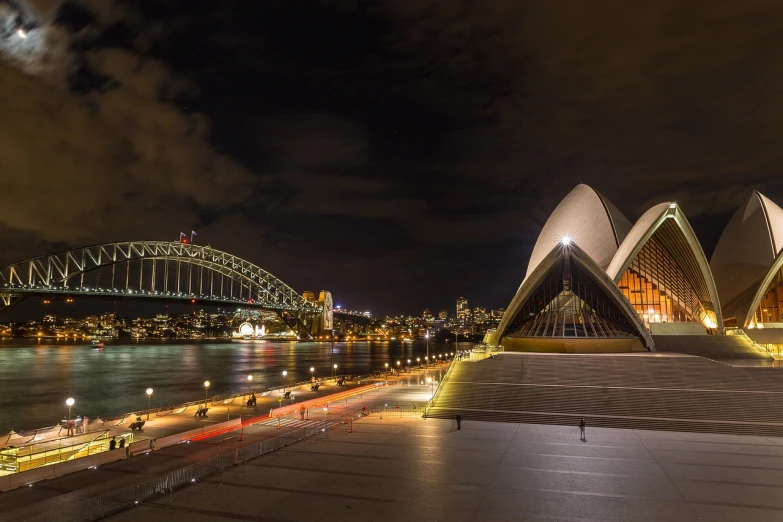 a view of the sydney opera house and harbour bridge at night, iso 1 0 0 wide view, tony roberts, beautifully lit buildings, concrete