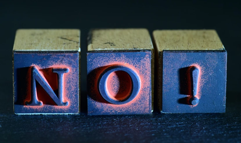 a close up of a wooden block with the word no, by Gavin Nolan, dark. no text, banner, rule of 3 rds, notes