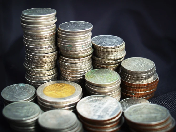 a pile of coins sitting on top of each other, a tilt shift photo, 35 mm product photo”