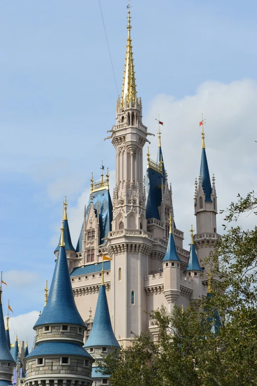 a castle with a clock tower surrounded by trees, a photo, inspired by disney, shutterstock, florida, majestic spires, crown, mouse photo