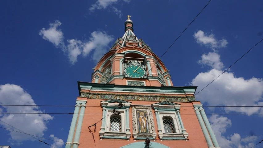 a clock that is on the side of a building, by Andrei Kolkoutine, art nouveau, in orthodox church, orange and teal color, lead - covered spire, russian and japanese mix