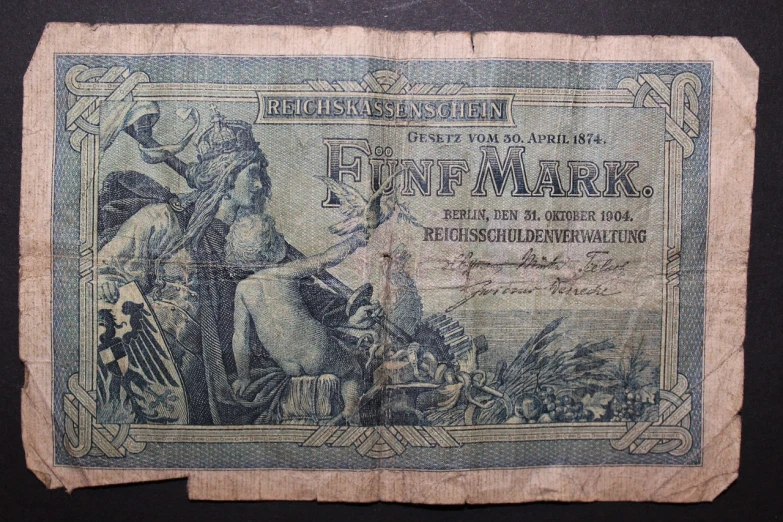a close up of a piece of paper on a table, by Hans Fischer, art nouveau, banknote, archeological find, wtf, mark mann