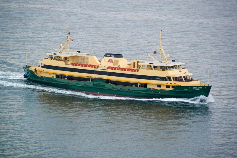 a large boat traveling across a body of water, yellow and olive color scheme, manly, completely new, near the sea