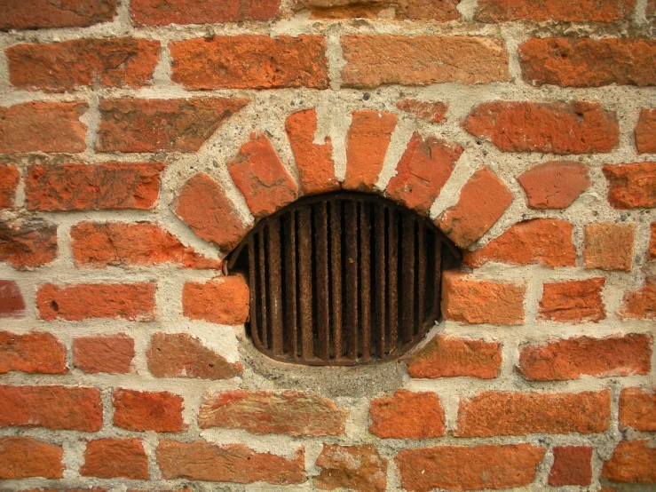 a brick wall with a hole in it, by Jan Stanisławski, shutterstock, renaissance, radiator, hobbit hole, cell bars, with a round face
