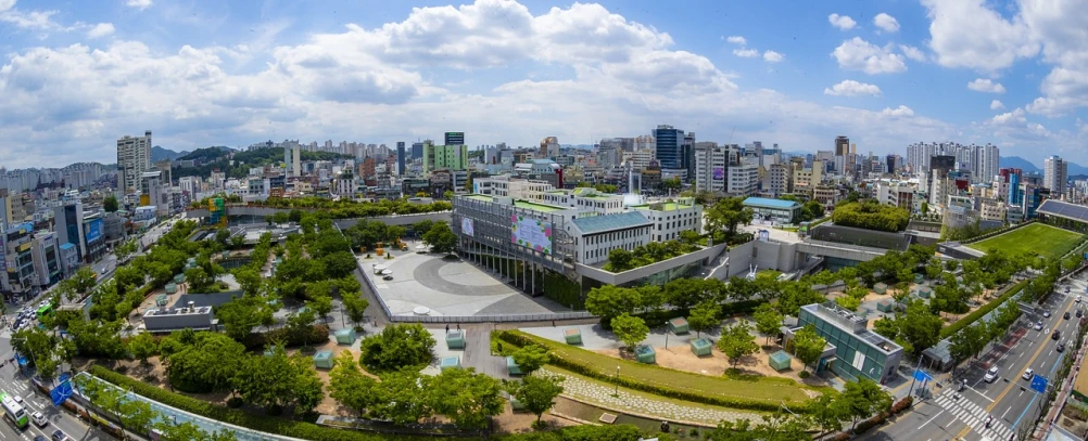 a view of a city from a bird's eye view, by Jang Seung-eop, wide panoramic shot, university, green square, wide angle 15mm lens