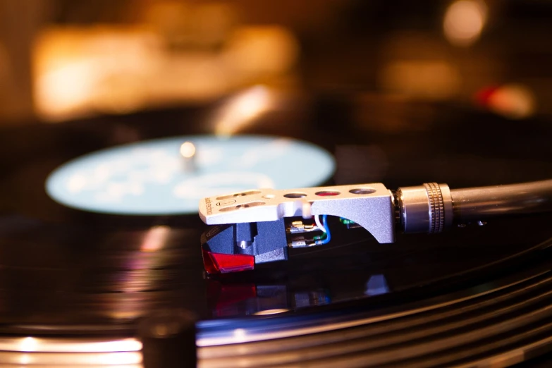 a close up of a record on a turntable, an album cover, by Jay Hambidge, shutterstock, turntablism dj scratching, museum quality photo, during the night, plays music