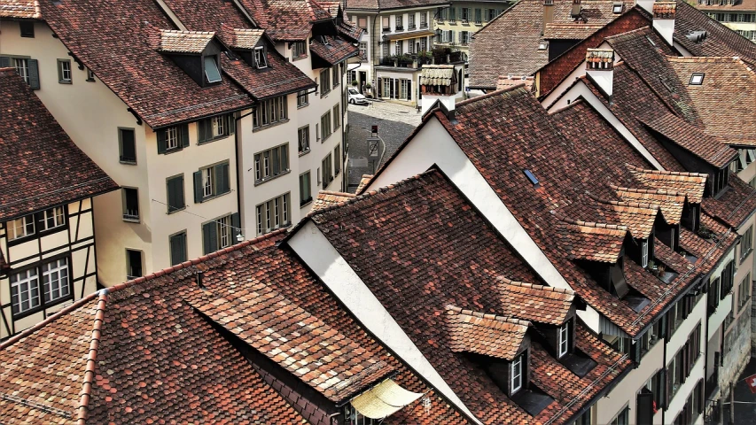 a group of buildings that are next to each other, inspired by Karl Stauffer-Bern, shutterstock, sharp roofs, badass composition, stained”, shade