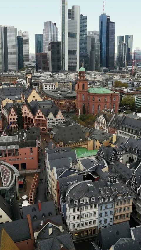 a view of a city from the top of a building, inspired by Georg Friedrich Schmidt, wikimedia commons, red building, germany. wide shot, japanese downtown