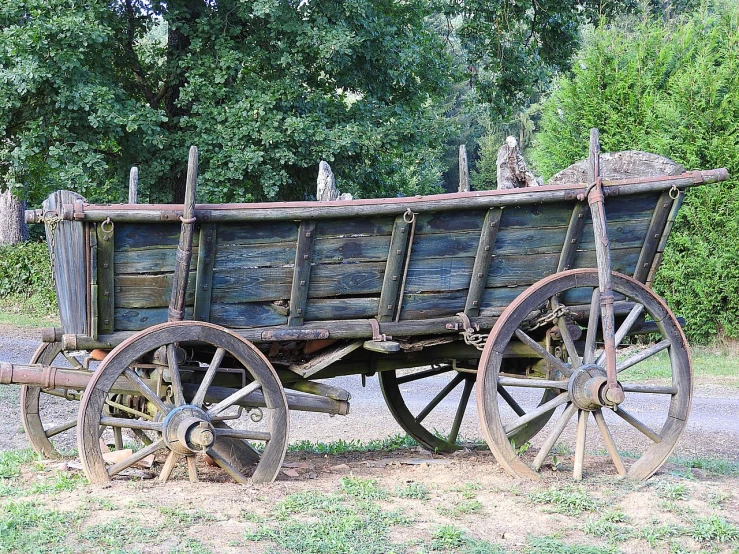 an old wooden wagon sitting on the side of a road, renaissance, viewed from the side, ebay photo, high resolution image, hurt