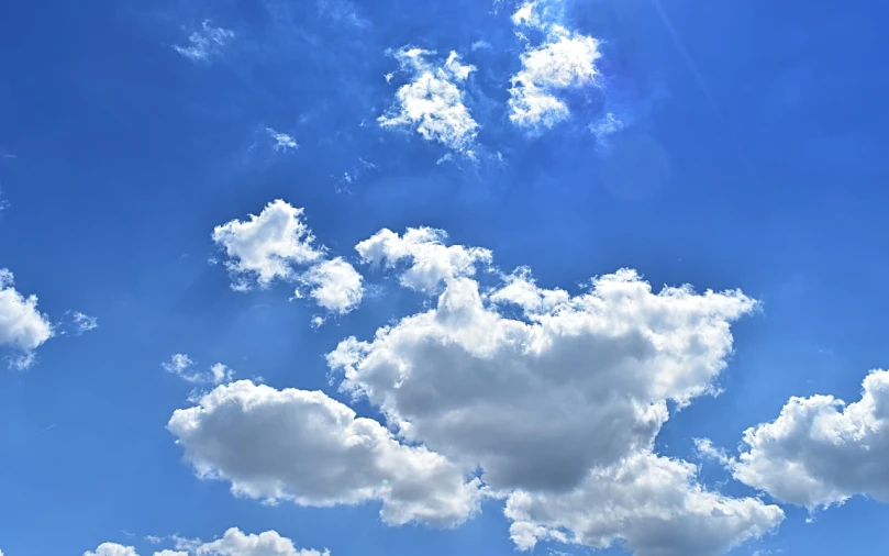 there is a plane that is flying in the sky, by Jan Rustem, precisionism, cumulus, blue sunny sky, cumulus cloud tattoos, in forcasted sky