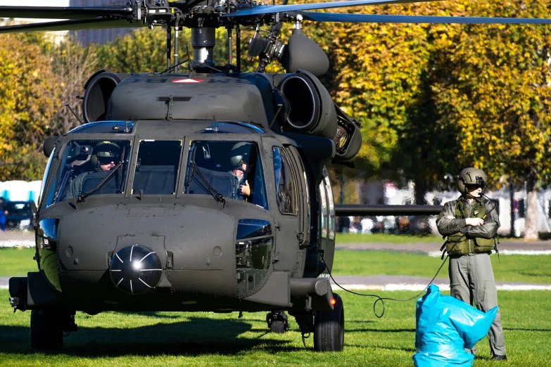 a helicopter sitting on top of a lush green field, a photo, by Arnie Swekel, military parade, november, washington dc, detail shots