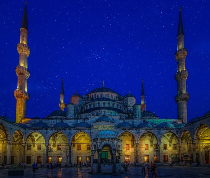 a large blue mosque lit up at night, shutterstock, tonemapping, night sky photography, a wide open courtyard in an epic, summer evening