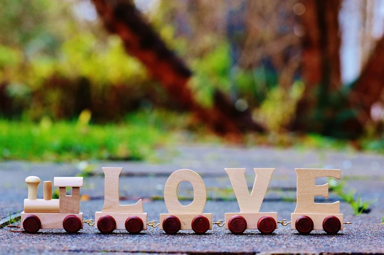 a wooden train with the word love spelled on it, a picture, by Zofia Stryjenska, trending on pixabay, wallpaper”, avatar image, ground view shot, banner