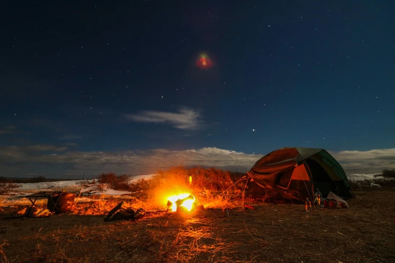 a tent sitting on top of a field next to a fire, a portrait, by Alexander Fedosav, tumblr, during lunar eclipse, in the steppe, all face covered with a fire, mars vacation photo