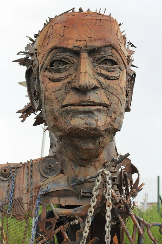 a sculpture of a man with chains around his neck, by Richard Carline, flickr, new sculpture, gigantic robot head, portrait of a slightly rusty, with lots of details, up close portrait of mr bean