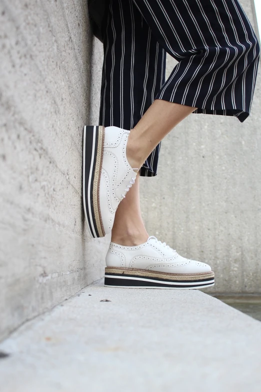 a person wearing striped pants and white shoes, a picture, inspired by Lucia Peka, trending on pixabay, arabesque, creepers, wearing heels and white dress, stacked, white steam on the side