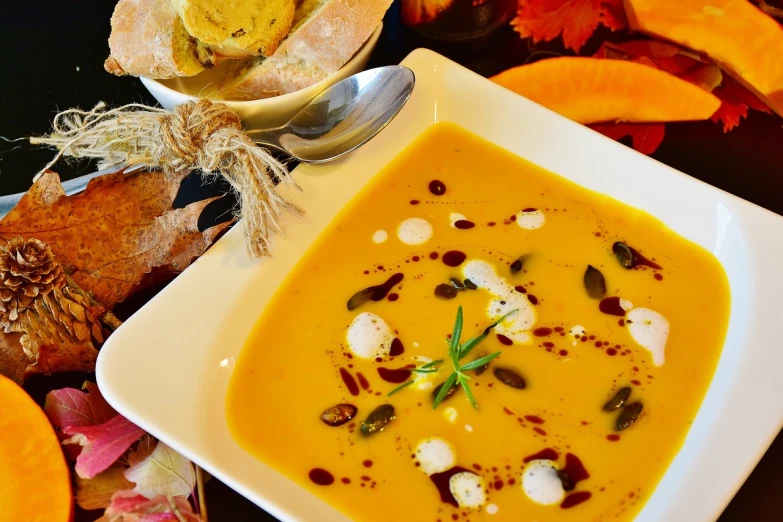 a bowl of soup sitting on top of a table, inspired by Charles Le Roux, pixabay, realism, harvest fall vibrance, salad and white colors in scheme, gourds, professional food photography