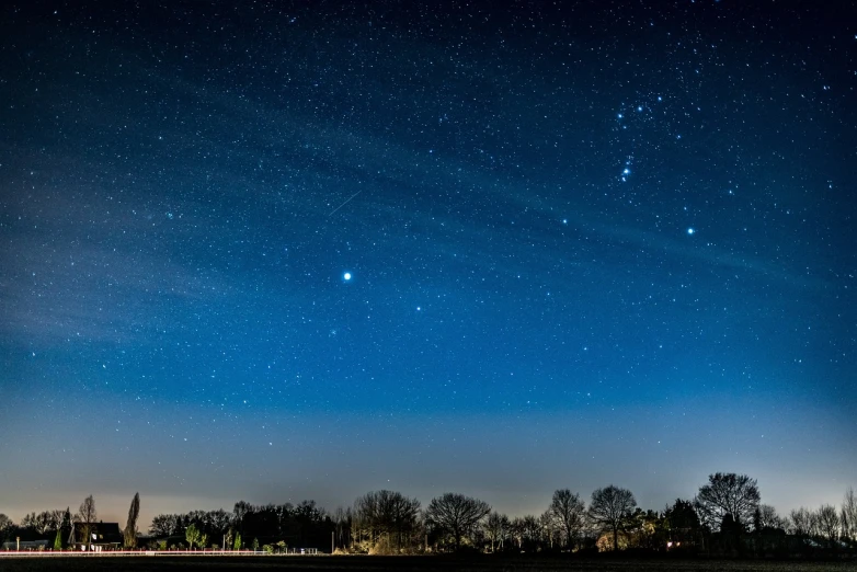 a night sky filled with lots of stars, by Jesper Knudsen, visible planets in the sky, photography shot at blue hour, comet, godrays from the right