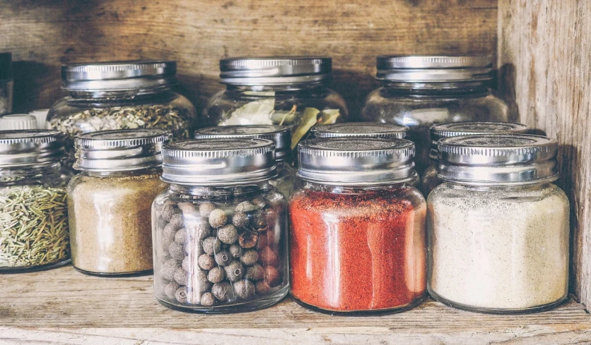 a shelf filled with lots of different types of spices, by Victoria Francés, pexels, glass jar, 🦩🪐🐞👩🏻🦳, vintage soft grainy, 🤠 using a 🖥