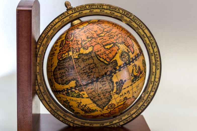 a globe sitting on top of a wooden stand, an engraving, cloisonnism, closeup photo, top angle view, information, close up photo