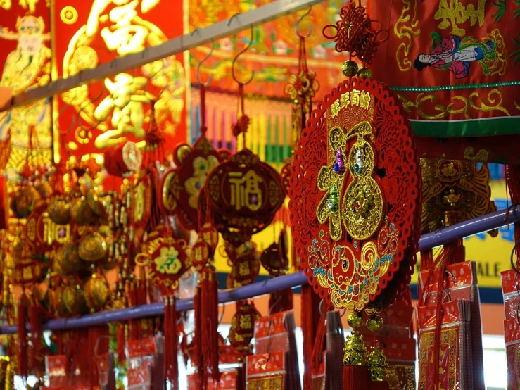 a room filled with lots of red and gold decorations, inspired by Gong Xian, flickr, colored market stand, golden ribbons, vivid composition, aum