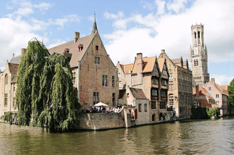 a river running through a city next to tall buildings, a photo, by Justus van Gent, renaissance, medieval house, wikipedia, photo taken from a boat, h 640