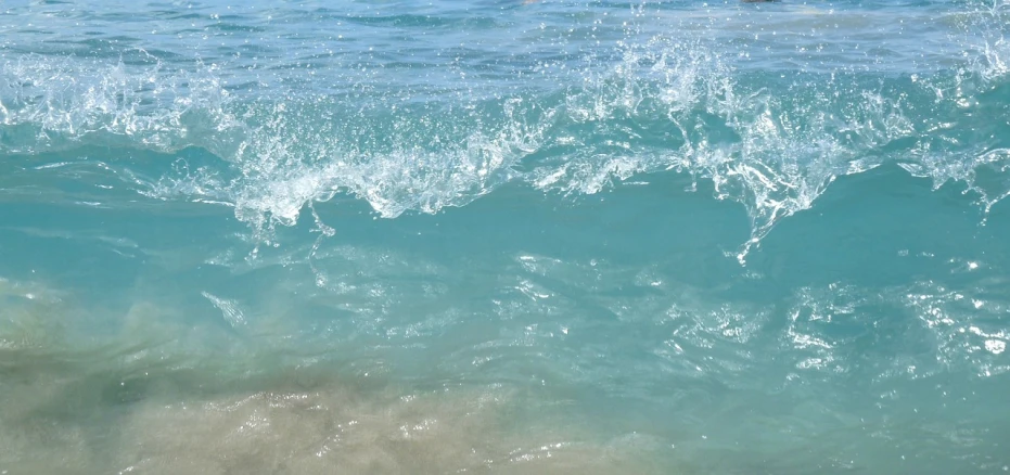 a man riding a wave on top of a surfboard, pexels, fine art, glistening seafoam, beach sand background, wallpaper - 1 0 2 4, background soft blue