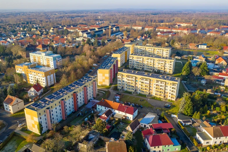 an aerial view of a city with lots of buildings, by Stefan Gierowski, shutterstock, bauhaus, zdzislaw, village, high angle uhd 8 k, soviet apartment buildings