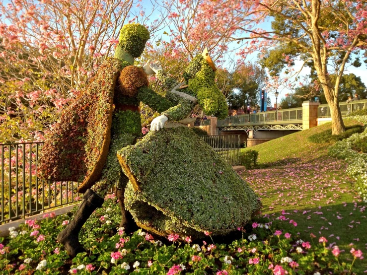 a statue of a man and a woman in a garden, inspired by disney, environmental art, dressed in a flower dress, disney world, 3 4 5 3 1
