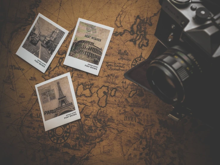 four polaroids sitting on top of a map next to a camera, old world, ( 3 1, high quality product image”