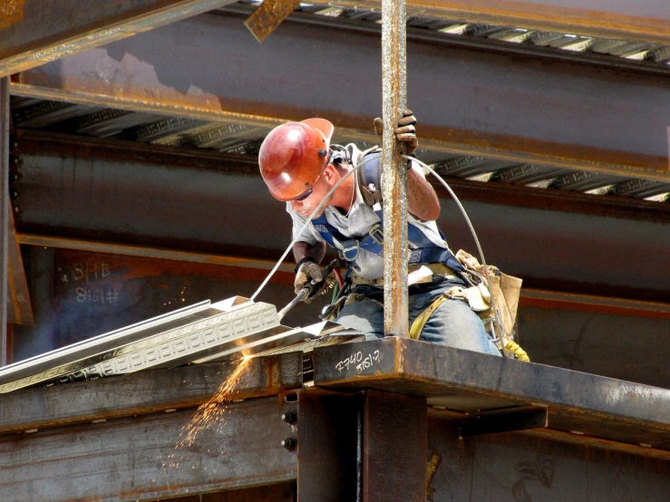 a construction worker working on the side of a building, by Douglas Shuler, renaissance, steel and metal, usa-sep 20, minn, 2 0 1 0 photo