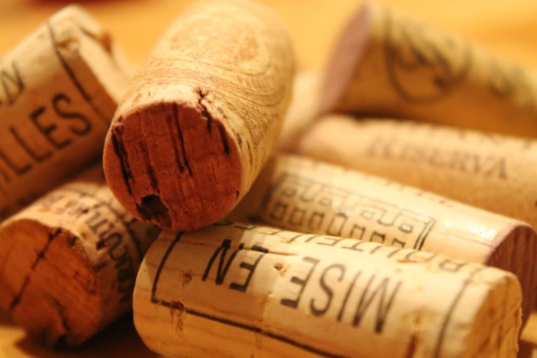 a pile of wine corks sitting on top of a table, a picture, istockphoto, seams, mid closeup, writings