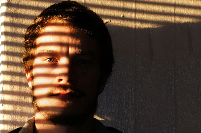 a man that is standing in front of a wall, a picture, by Jan Rustem, flickr, soft light through blinds, stubble on his face, in the sun, ryan church