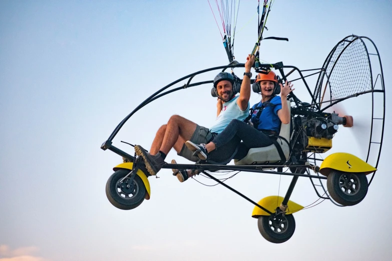 a couple of people riding on top of a motorcycle, ornithopter, aero dynamic, buggy, family friendly