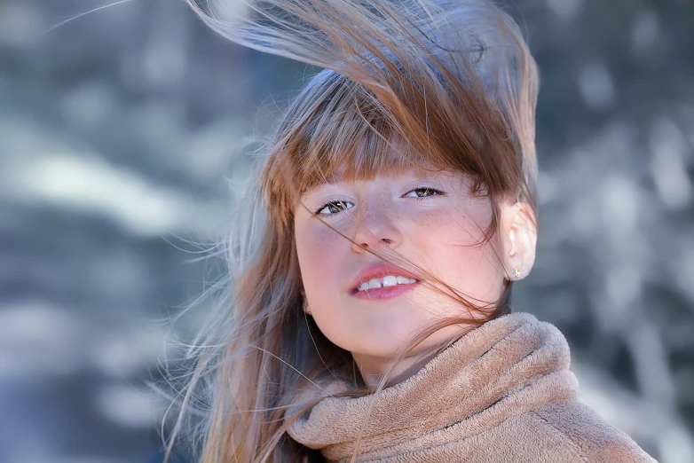 a young girl with her hair blowing in the wind, a portrait, trending on pixabay, frozen cold stare, retouched in photoshop, big brown fringe, young child