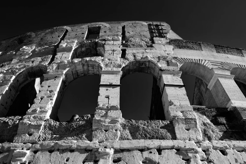 a black and white photo of a roman colossion, a black and white photo, pexels contest winner, romanesque, torn edges, little windows, colosseo, iso 1 0 0 wide view