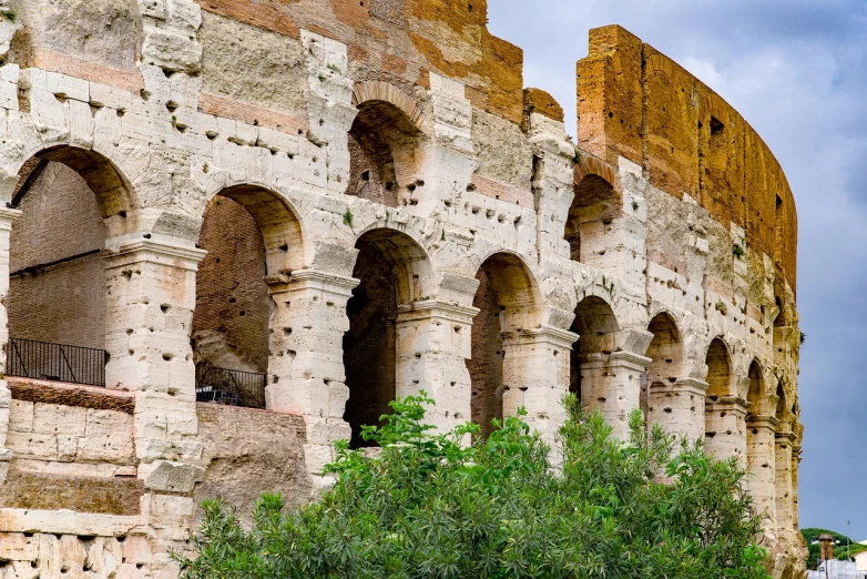 a couple of people that are standing in front of a building, inspired by Romano Vio, shutterstock, inside the roman colliseum, profile close-up view, wall structure, covered with vegetation