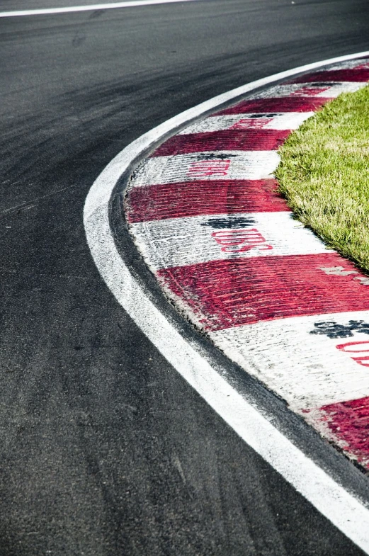 a person riding a motorcycle on a race track, by Richard Carline, shutterstock, folk art, detail texture, sao paulo, corner, marking lines