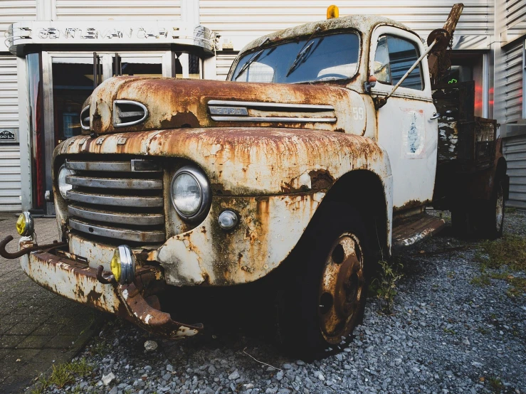 an old rusted truck parked in front of a building, unsplash, photorealism, ford, stock photo, usa-sep 20, stunning face