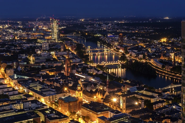 an aerial view of a city at night, a picture, by Thomas Häfner, the river is full of lights, city skyline in the backround, in a city with a rich history, summer morning