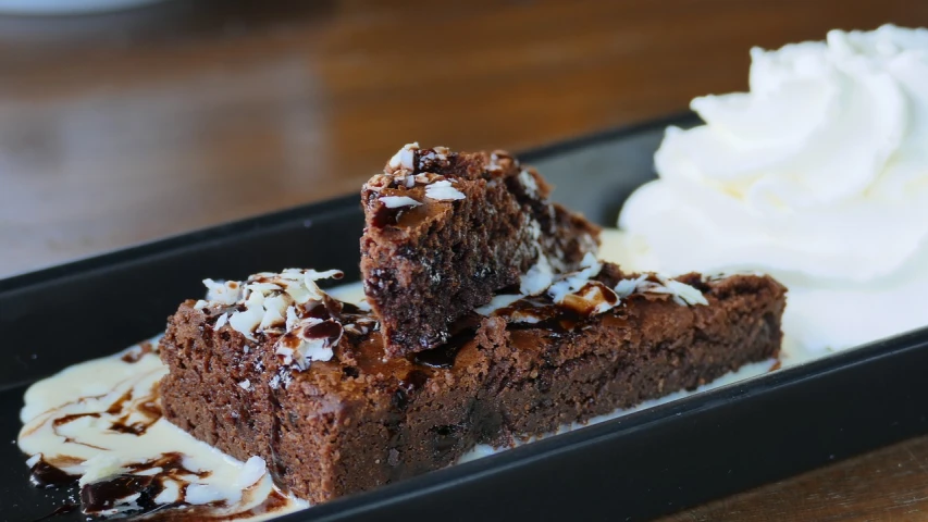 a close up of a plate of food on a table, by Robbie Trevino, smothered in melted chocolate, outback, square, rails